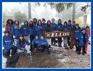 Students around a sign that reads Willow